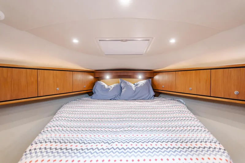 Worked The Plan Yacht Photos Pics 2009 Tiara Yachts 3900 Sovran cabin with cozy bed and wooden storage cabinets.