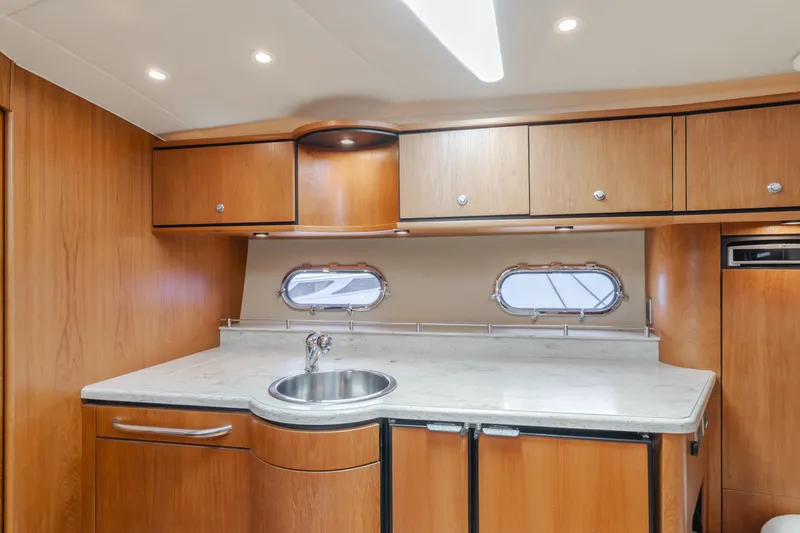 Worked The Plan Yacht Photos Pics 2009 Tiara Yachts 3900 Sovran interior kitchen with wood cabinets and round sink.