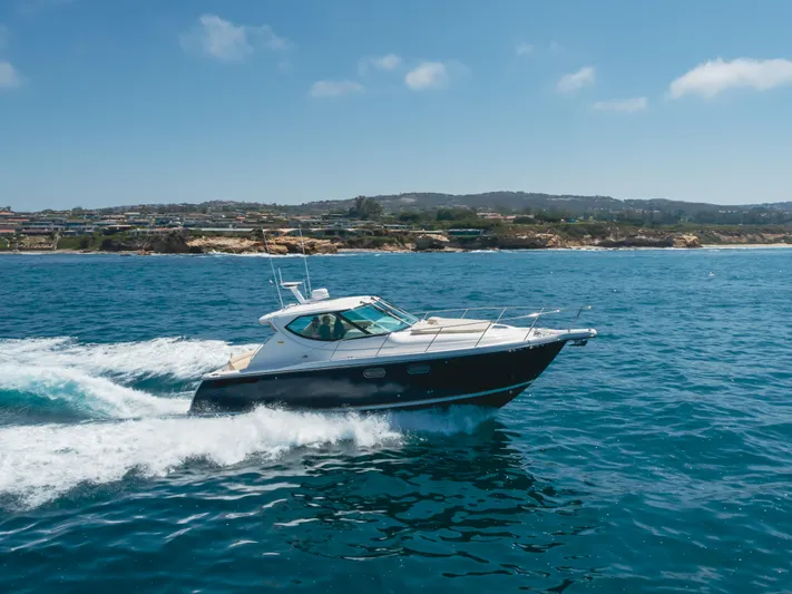 Worked The Plan Yacht Photos Pics 2009 Tiara Yachts 3900 Sovran cruising on blue ocean near coastline.