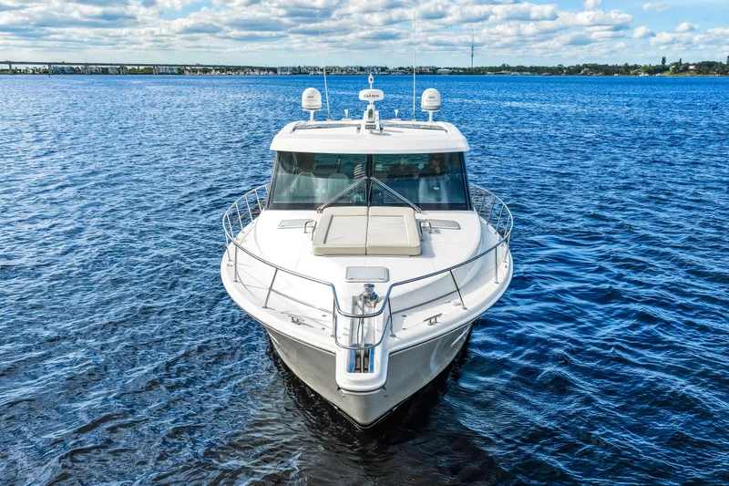 Escape Pod Yacht Photos Pics 2015 Riviera 565 SUV yacht cruising on open water under a partly cloudy sky.