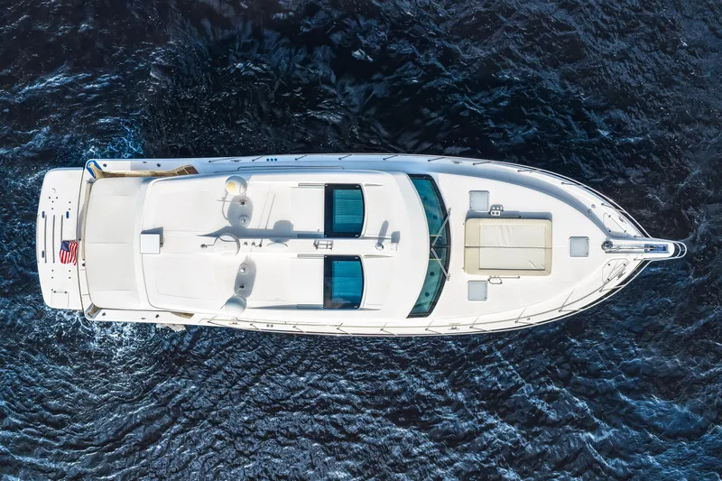 Escape Pod Yacht Photos Pics Aerial view of 2015 Riviera 565 SUV yacht on open water.