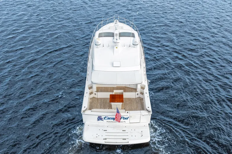 Escape Pod Yacht Photos Pics Aerial view of 2015 Riviera 565 SUV yacht cruising on open water.