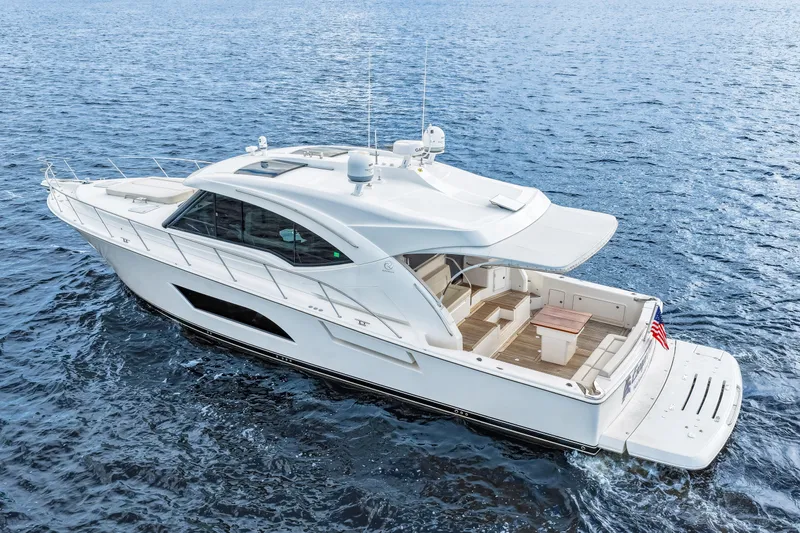Escape Pod Yacht Photos Pics 2015 Riviera 565 SUV yacht cruising on open water, showcasing sleek design and spacious deck.