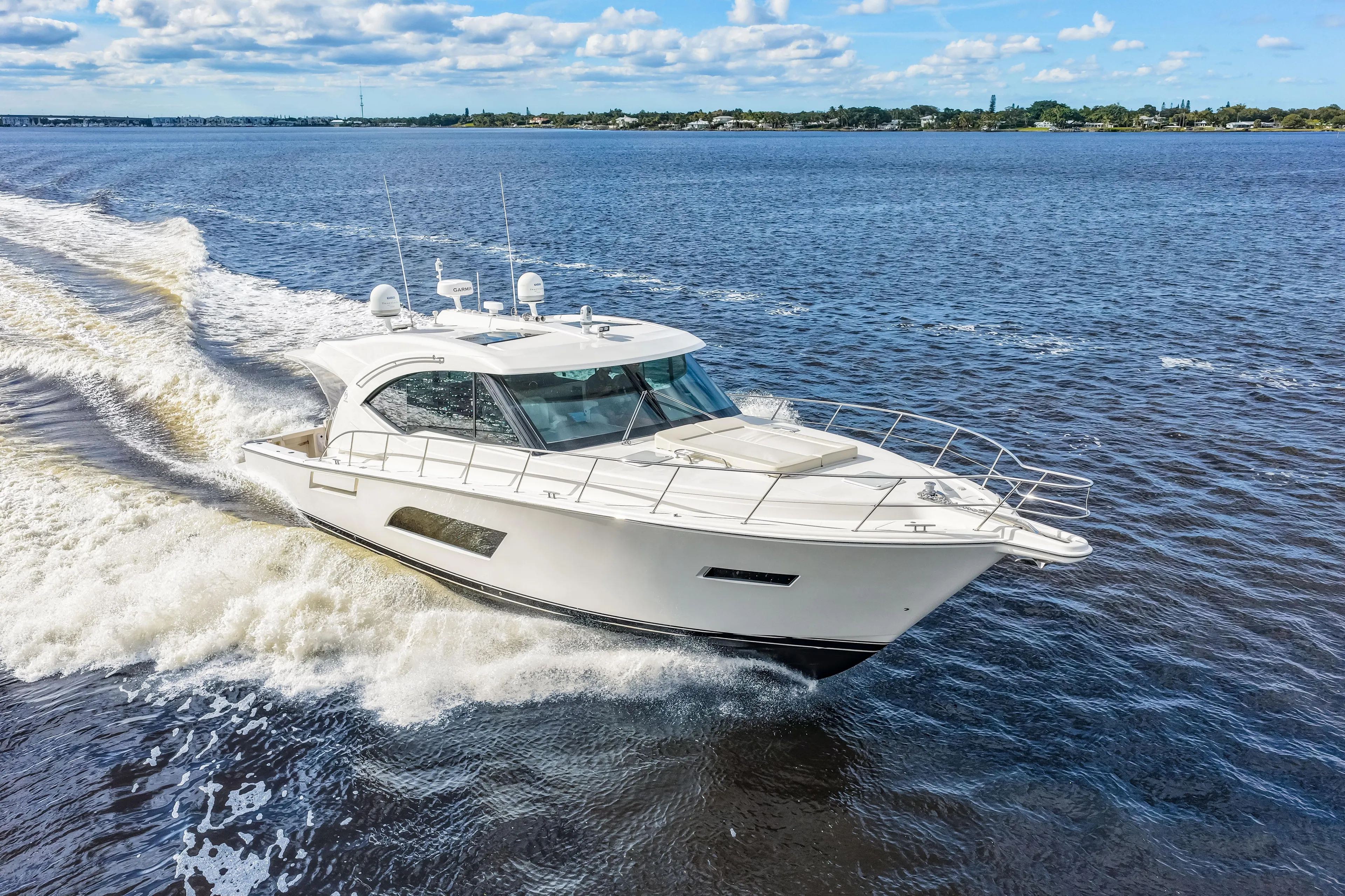 Escape Pod Yacht Photos Pics 2015 Riviera 565 SUV yacht cruising on open water under a clear sky.