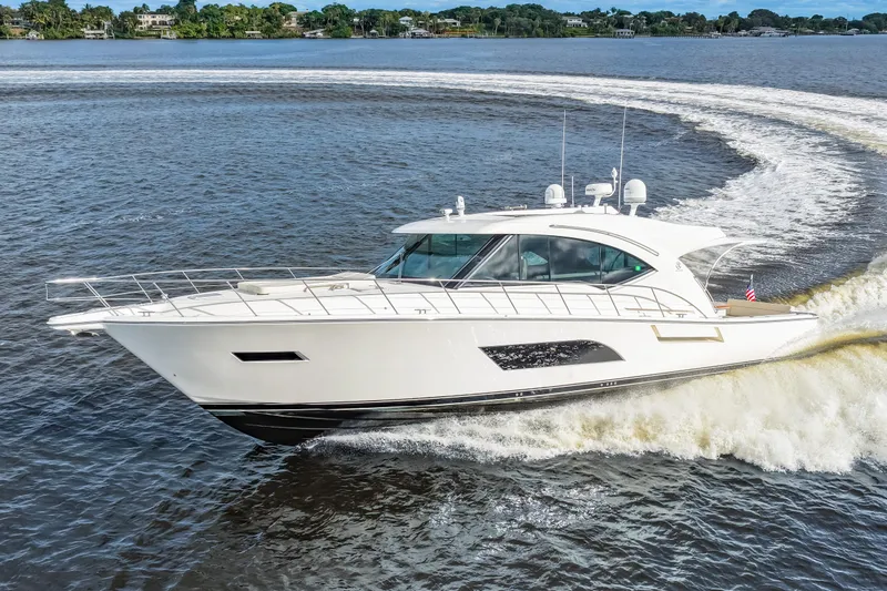 Escape Pod Yacht Photos Pics 2015 Riviera 565 SUV yacht cruising on open water, creating a dynamic wake.