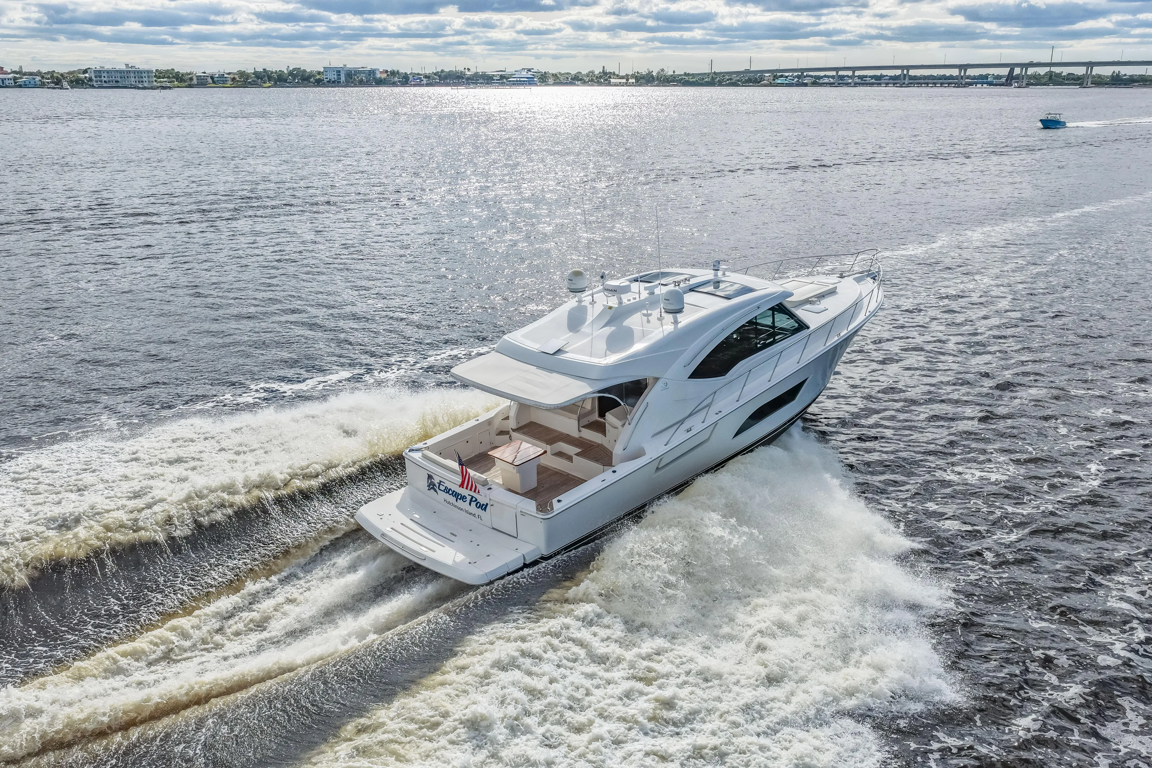 Escape Pod Yacht Photos Pics 2015 Riviera 565 SUV cruising on open water, creating a dynamic wake.