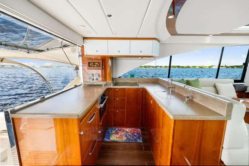 Escape Pod Yacht Photos Pics Luxurious interior of 2015 Riviera 565 SUV yacht with modern kitchen and scenic water view.