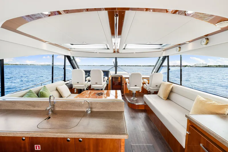 Escape Pod Yacht Photos Pics Luxurious interior of 2015 Riviera 565 SUV yacht with ocean view and elegant seating.