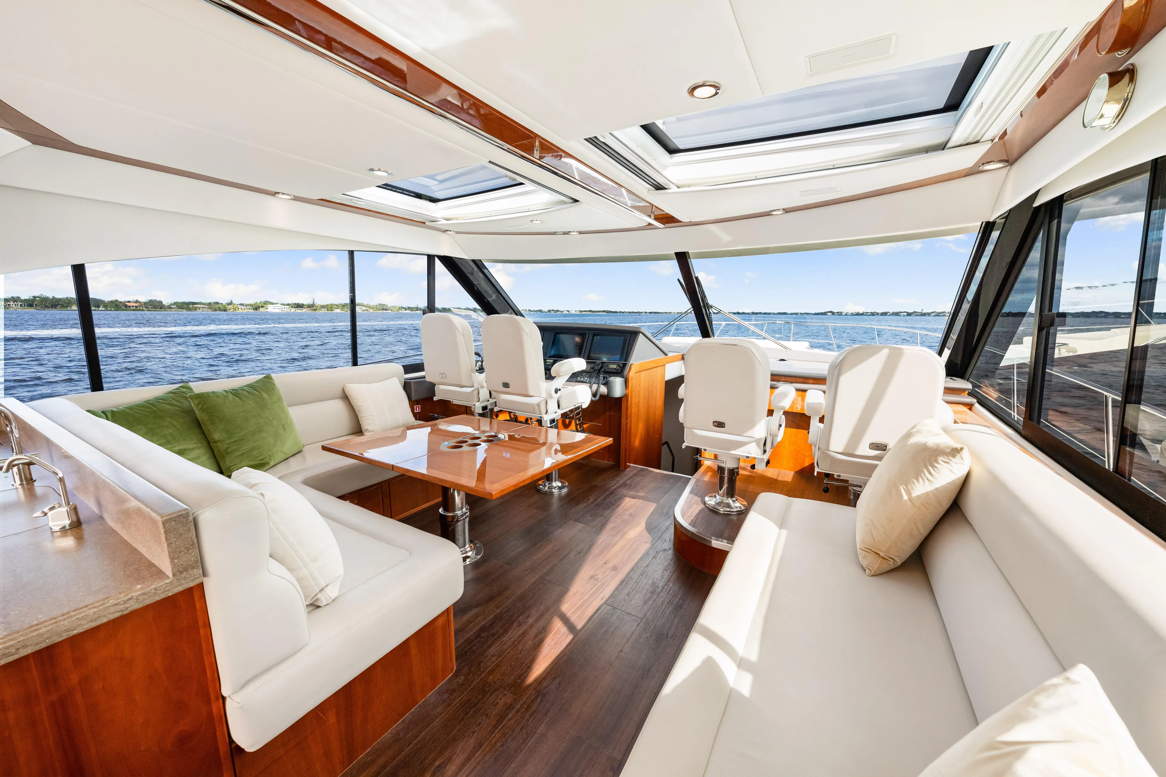 Escape Pod Yacht Photos Pics Luxurious interior of 2015 Riviera 565 SUV yacht with plush seating and panoramic windows.