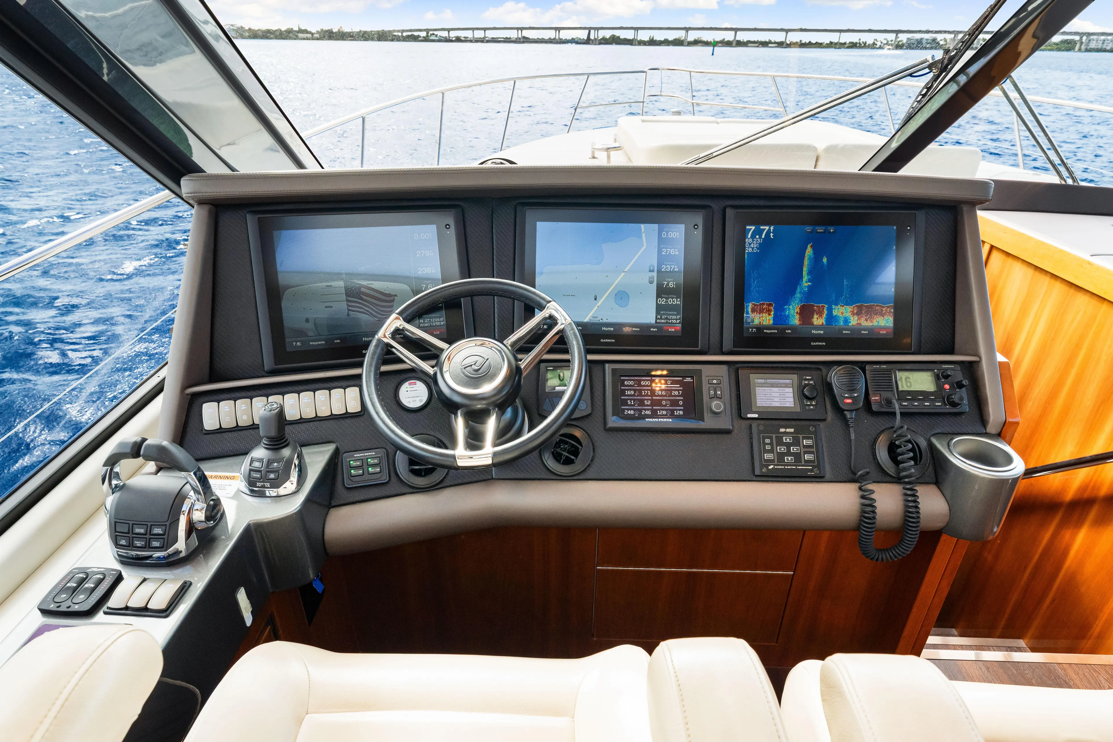 Escape Pod Yacht Photos Pics Control panel of 2015 Riviera 565 SUV yacht with navigation screens and steering wheel.