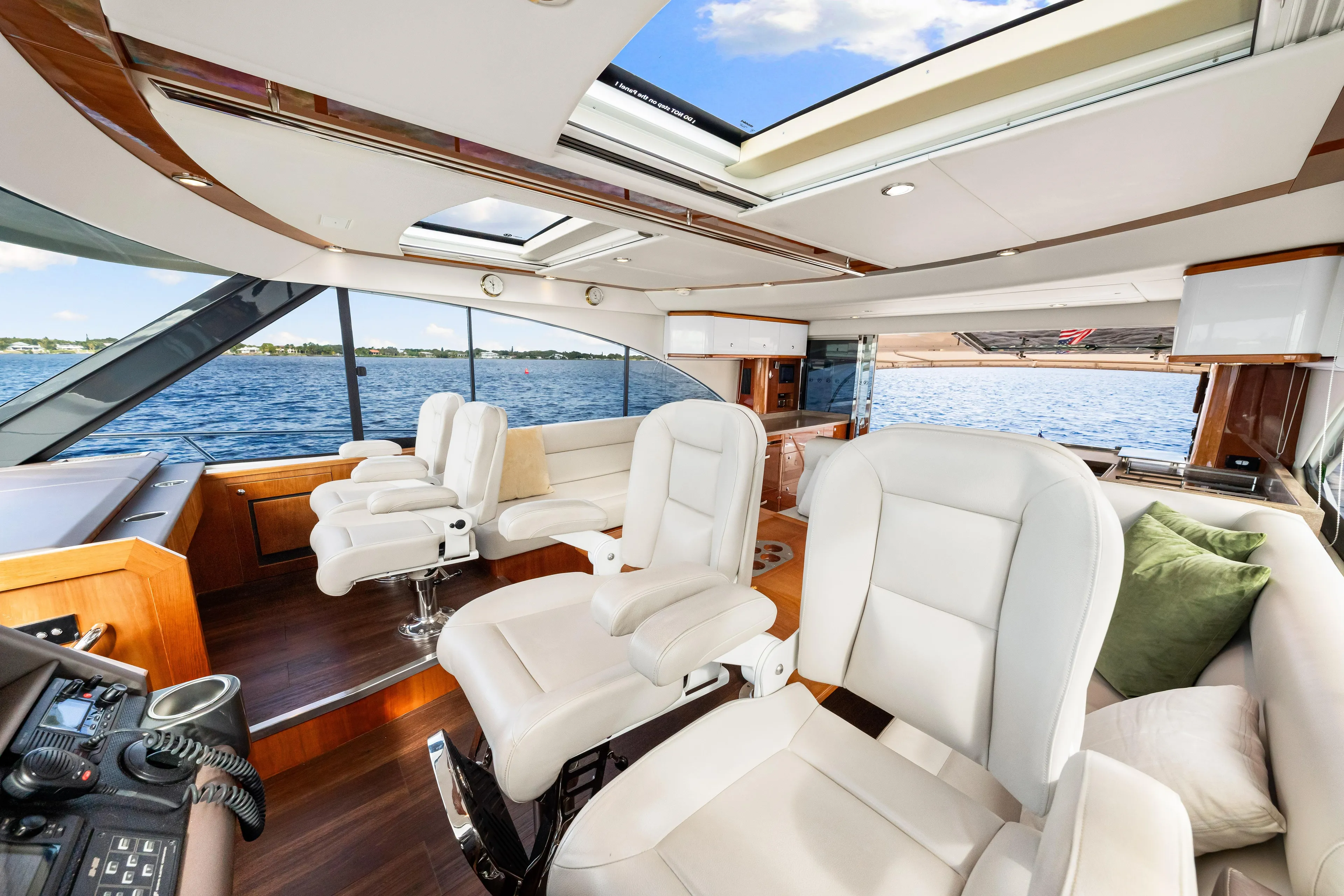 Escape Pod Yacht Photos Pics Luxurious interior of 2015 Riviera 565 SUV yacht with plush seating and panoramic windows.