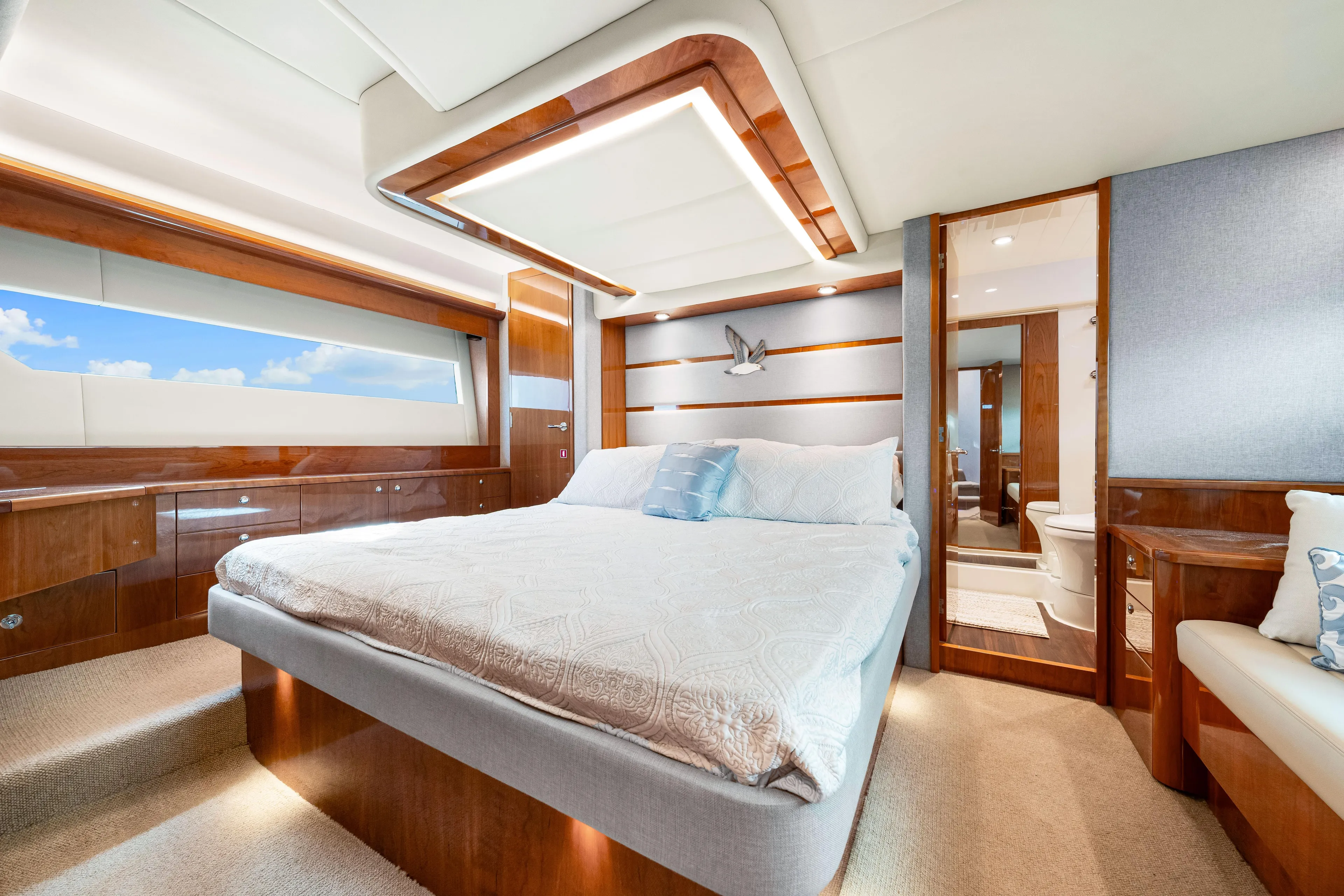 Escape Pod Yacht Photos Pics Luxurious master stateroom of 2015 Riviera 565 SUV yacht with elegant wood finishes.