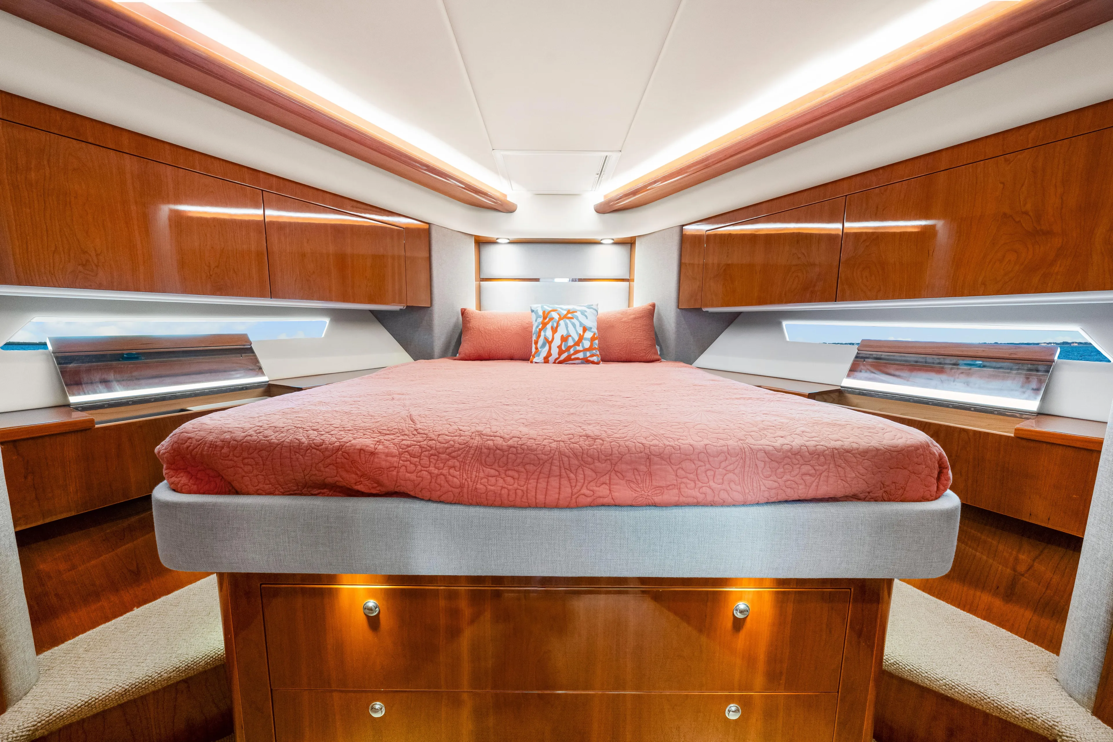 Escape Pod Yacht Photos Pics Luxurious 2015 Riviera 565 SUV yacht bedroom with elegant wood finish and coral bedding.