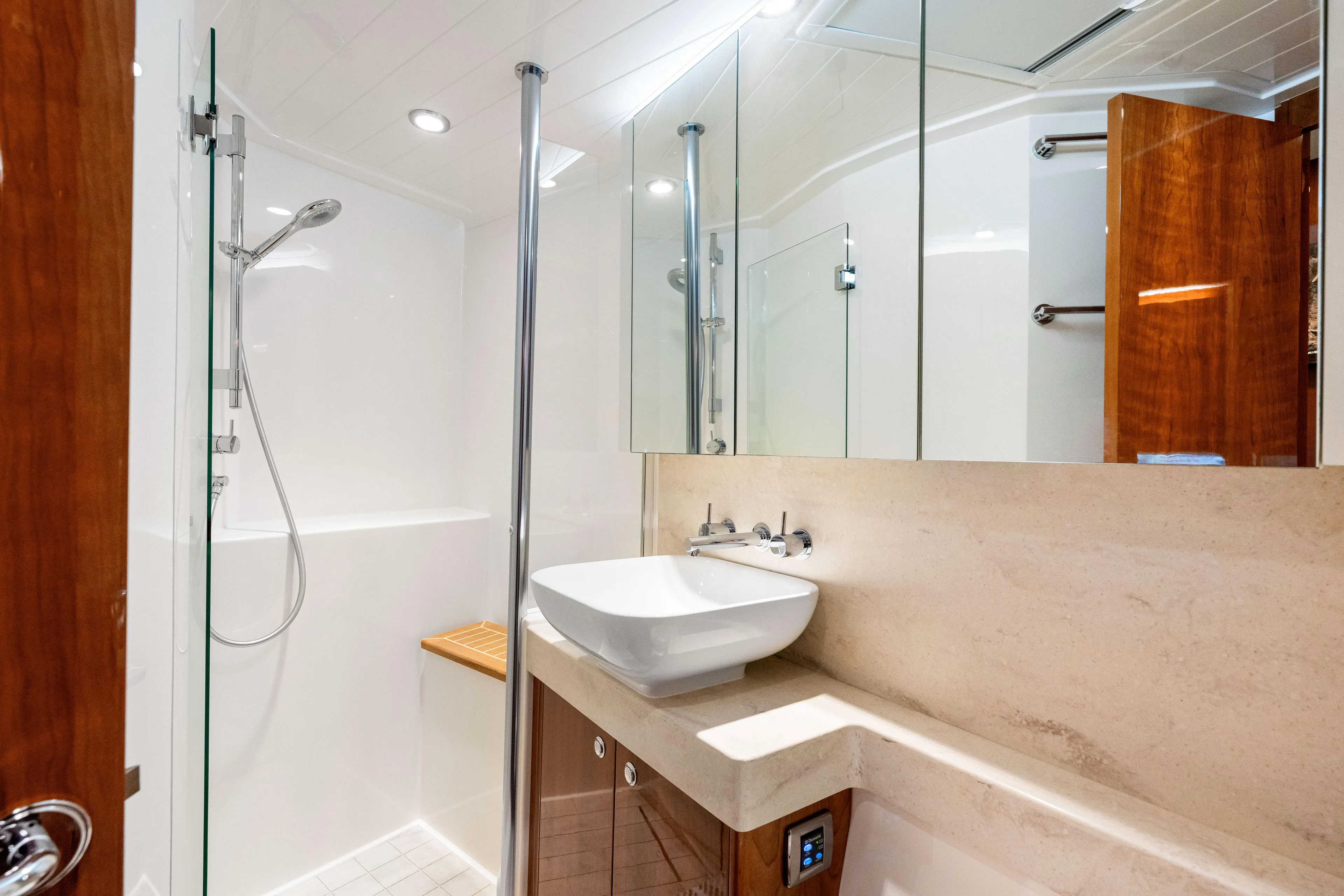 Escape Pod Yacht Photos Pics Luxurious bathroom in 2015 Riviera 565 SUV yacht with modern fixtures and elegant design.