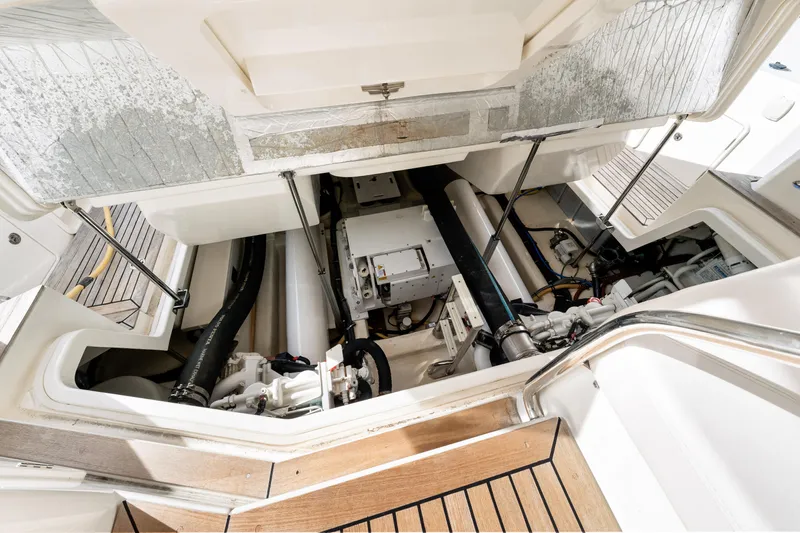 Escape Pod Yacht Photos Pics Engine compartment of a 2015 Riviera 565 SUV yacht, showcasing mechanical components and layout.