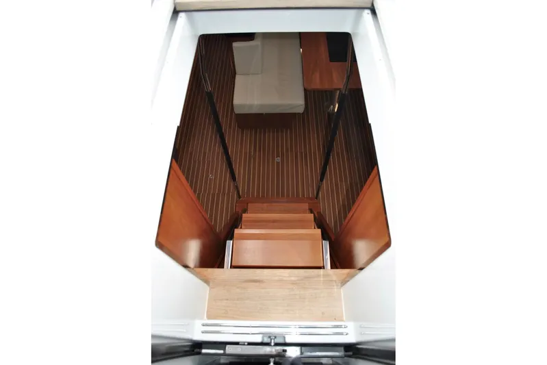 First Light Yacht Photos Pics Interior view of 2017 Hanse 505 yacht, featuring wooden stairs and flooring.