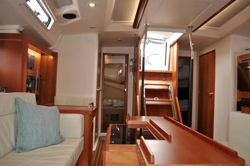 First Light Yacht Photos Pics Interior of 2017 Hanse 505 yacht with modern wood finish and comfortable seating.