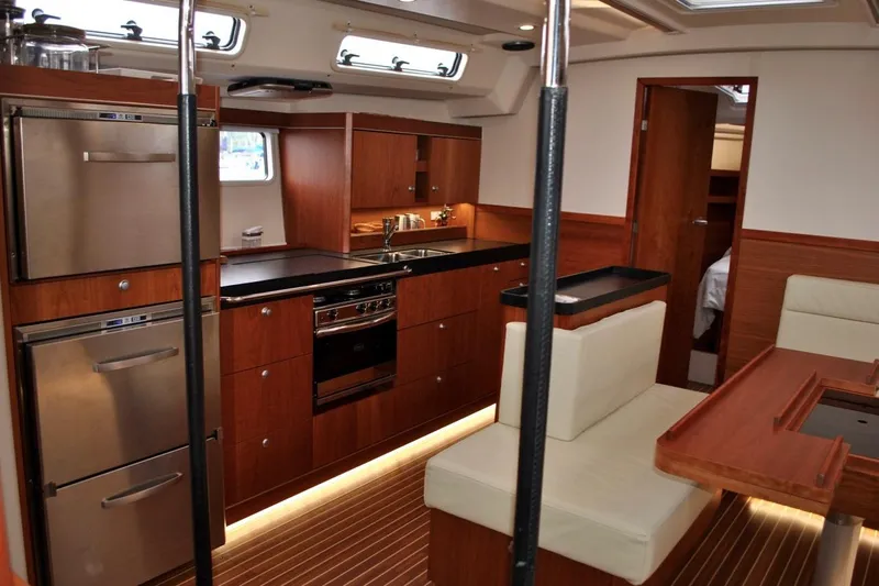 First Light Yacht Photos Pics Luxurious interior of 2017 Hanse 505 yacht with modern kitchen and seating area.