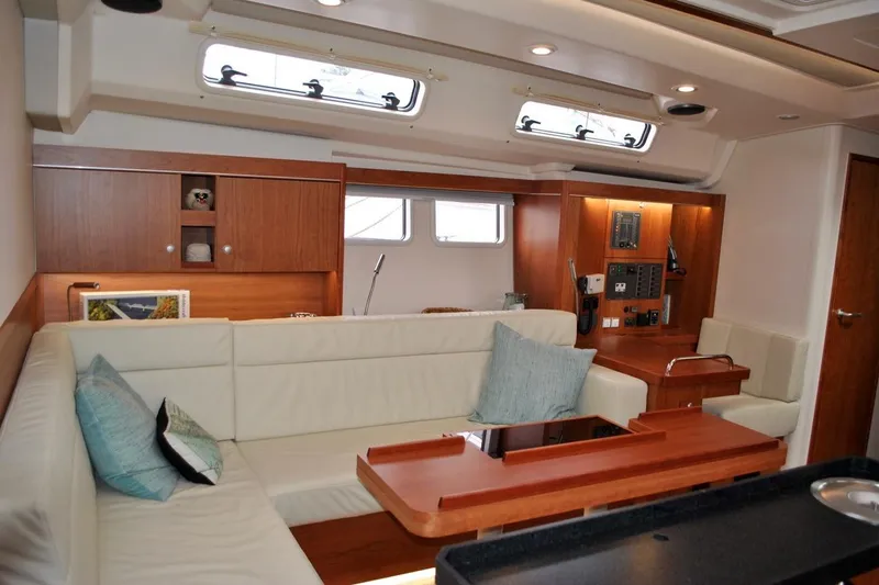 First Light Yacht Photos Pics Luxurious interior of 2017 Hanse 505 yacht with elegant seating and wooden cabinetry.