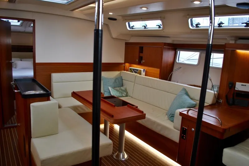 First Light Yacht Photos Pics Luxurious interior of 2017 Hanse 505 yacht with elegant seating and wooden finishes.