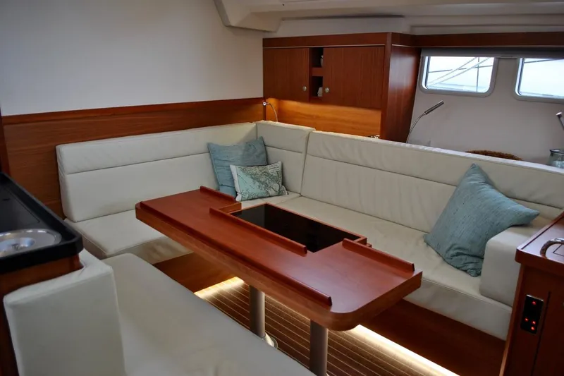 First Light Yacht Photos Pics Luxurious interior of 2017 Hanse 505 yacht with elegant seating and wooden table.