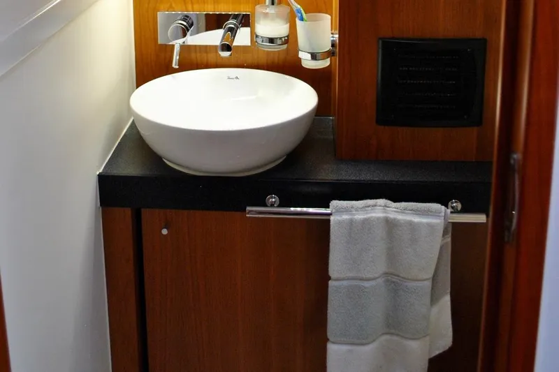 First Light Yacht Photos Pics Bathroom sink area in 2017 Hanse 505 yacht with wooden cabinetry.