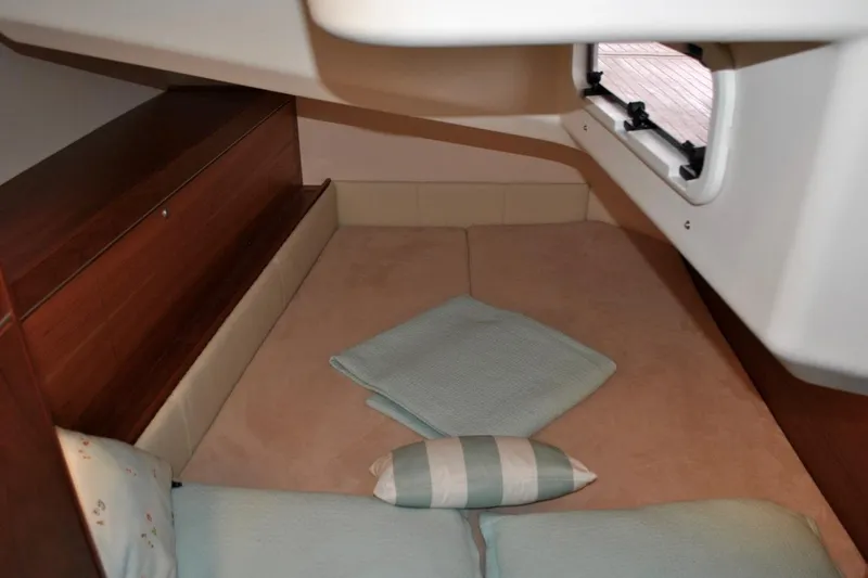 First Light Yacht Photos Pics 2017 Hanse 505 yacht cabin interior with cozy bedding and window view.