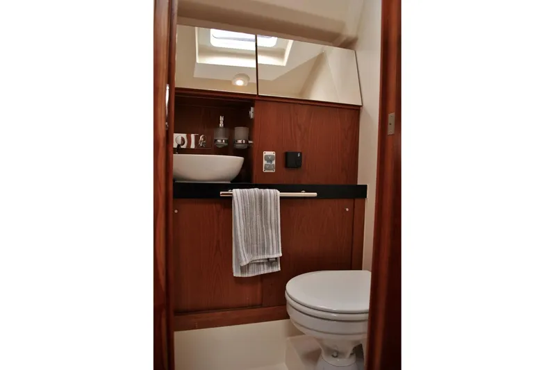 First Light Yacht Photos Pics Bathroom interior of 2017 Hanse 505 yacht with modern fixtures and wooden cabinetry.