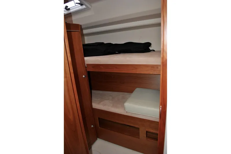 First Light Yacht Photos Pics 2017 Hanse 505 yacht interior with wooden bunk beds and storage.