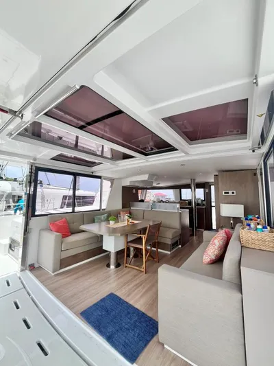 Sea Dog Yacht Photos Pics Modern interior of 2023 Bali 4.6 catamaran with spacious seating and dining area.