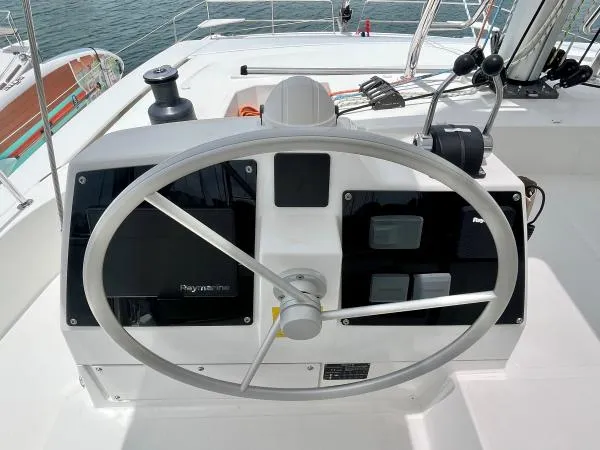 Sea Dog Yacht Photos Pics Steering wheel of a 2023 Bali 4.6 yacht with navigation controls.