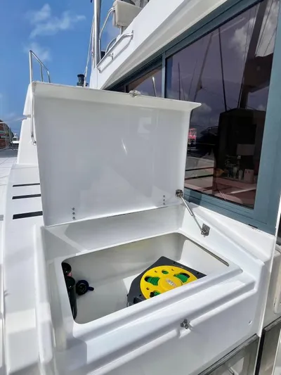 Sea Dog Yacht Photos Pics Open storage compartment on 2023 Bali 4.6 yacht, featuring a coiled hose reel.