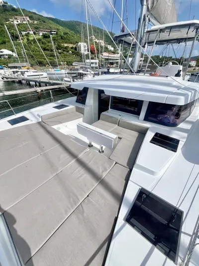 Sea Dog Yacht Photos Pics 2023 Bali 4.6 yacht with spacious deck and seating, docked in a scenic marina.