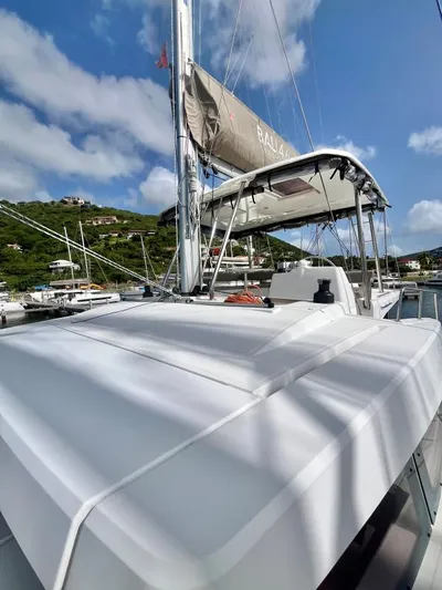 Sea Dog Yacht Photos Pics 2023 Bali 4.6 catamaran docked, showcasing sleek design and sails under a clear blue sky.