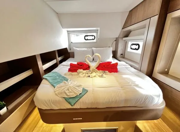 Sea Dog Yacht Photos Pics Luxurious Bali 4.6 yacht cabin with elegant bedding and towel swans, 2023 model.
