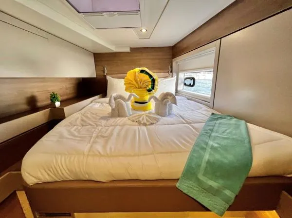 Sea Dog Yacht Photos Pics Luxurious Bali 4.6 yacht bedroom with elegant towel art and modern decor, 2023 model.