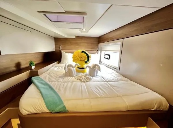 Sea Dog Yacht Photos Pics Cozy cabin interior of 2023 Bali 4.6 yacht with elegant bed and towel art.