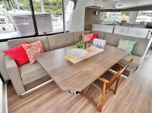 Sea Dog Yacht Photos Pics Luxurious interior of 2023 Bali 4.6 yacht with elegant dining area and colorful cushions.