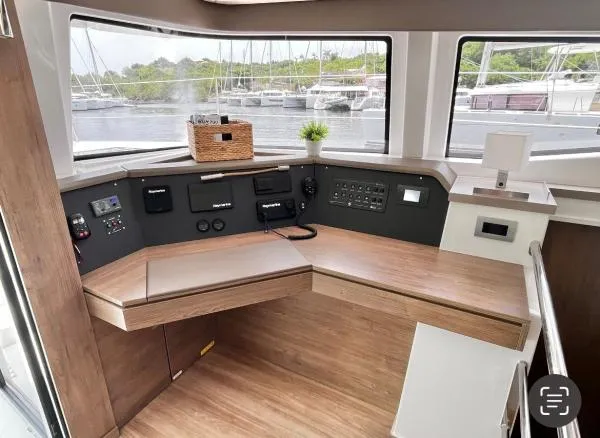 Sea Dog Yacht Photos Pics Modern helm station of 2023 Bali 4.6 yacht with wooden finish and control panels.