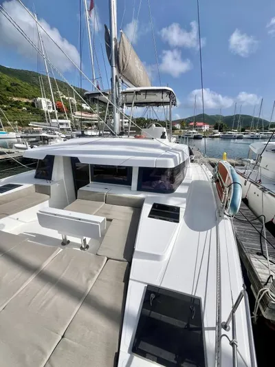 Sea Dog Yacht Photos Pics 2023 Bali 4.6 catamaran docked at marina, featuring spacious deck and modern design.