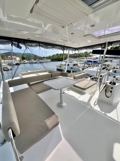 Sea Dog Yacht Photos Pics Modern Bali 4.6 yacht deck with seating and table, docked at marina, 2023 model.