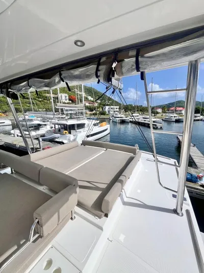 Sea Dog Yacht Photos Pics Modern Bali 4.6 yacht deck with sun loungers, docked in a scenic marina, 2023 model.