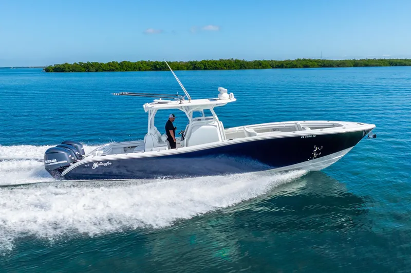  Yacht Photos Pics 2016 Yellowfin 36 Offshore boat cruising on clear blue water.