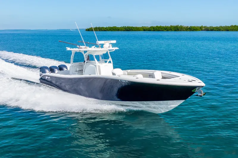  Yacht Photos Pics 2016 Yellowfin 36 Offshore boat cruising on clear blue water.