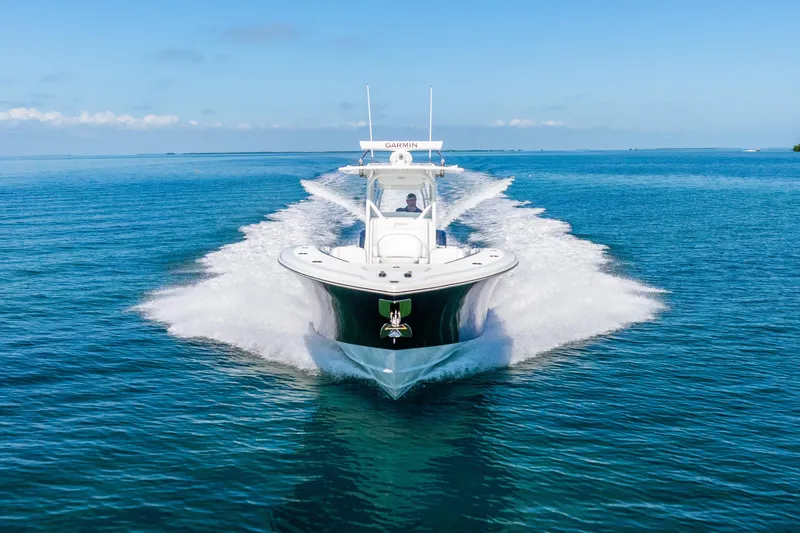  Yacht Photos Pics 2016 Yellowfin 36 Offshore boat cruising on clear blue water.