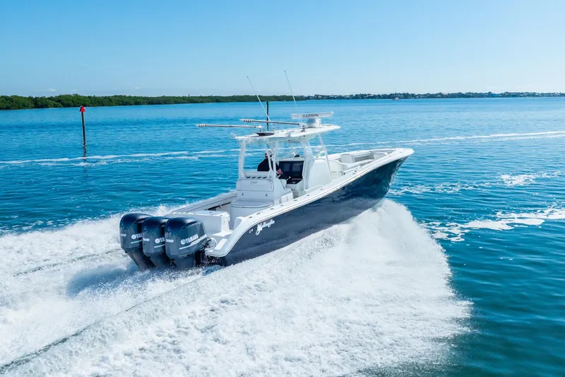  Yacht Photos Pics 2016 Yellowfin 36 Offshore boat cruising on open water with triple Yamaha engines.