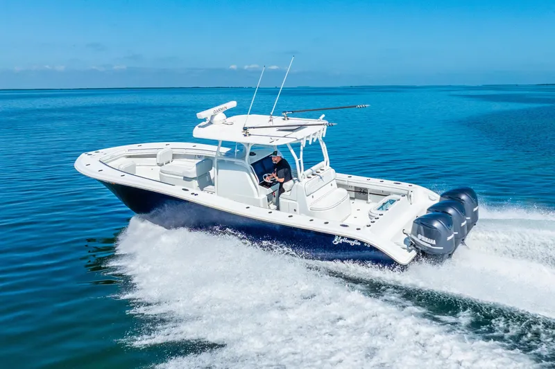  Yacht Photos Pics 2016 Yellowfin 36 Offshore boat cruising on clear blue water.