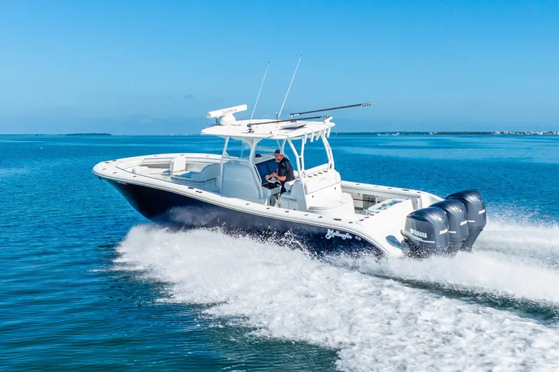  Yacht Photos Pics 2016 Yellowfin 36 Offshore boat cruising on clear blue water.
