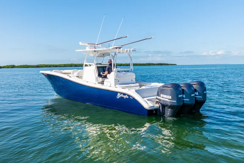  Yacht Photos Pics 2016 Yellowfin 36 Offshore boat with triple Yamaha engines on calm water.