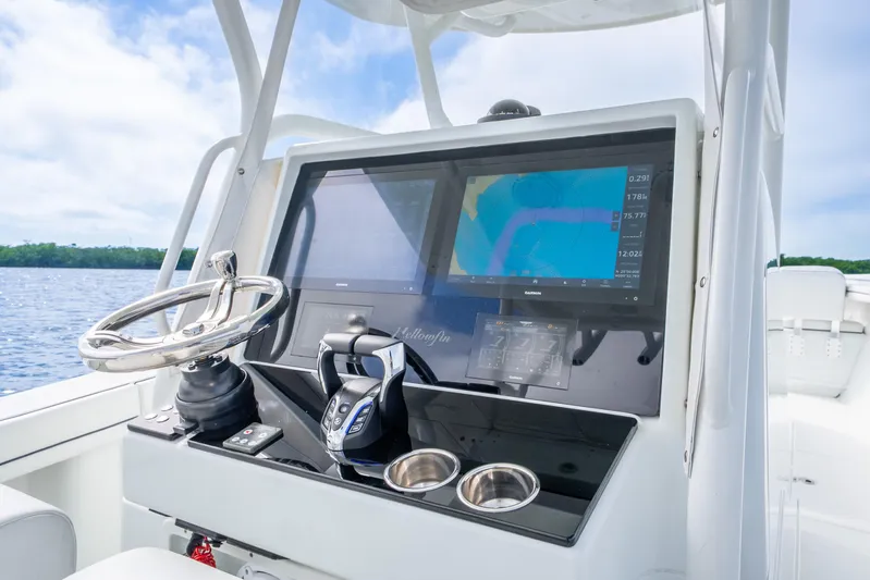  Yacht Photos Pics 2016 Yellowfin 36 Offshore boat dashboard with navigation screens and steering wheel.